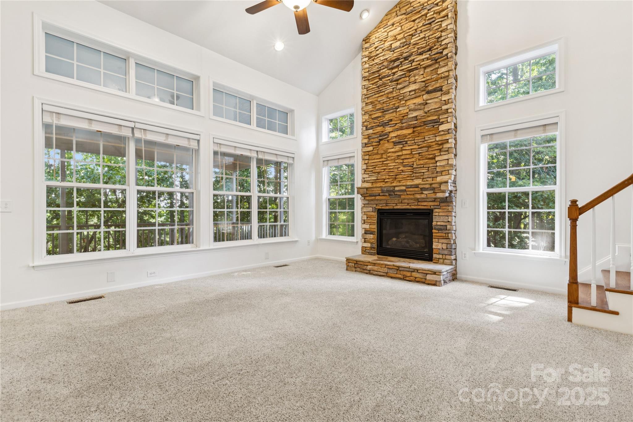 1627 Scotch Pine Lane Tega Cay, SC 29708 - Photo 14 of 48 a view of an empty room with a fireplace and windows