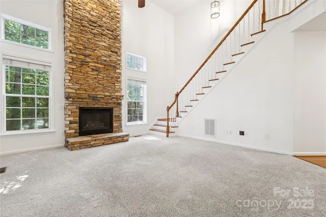 a view of empty room with fireplace and stairs