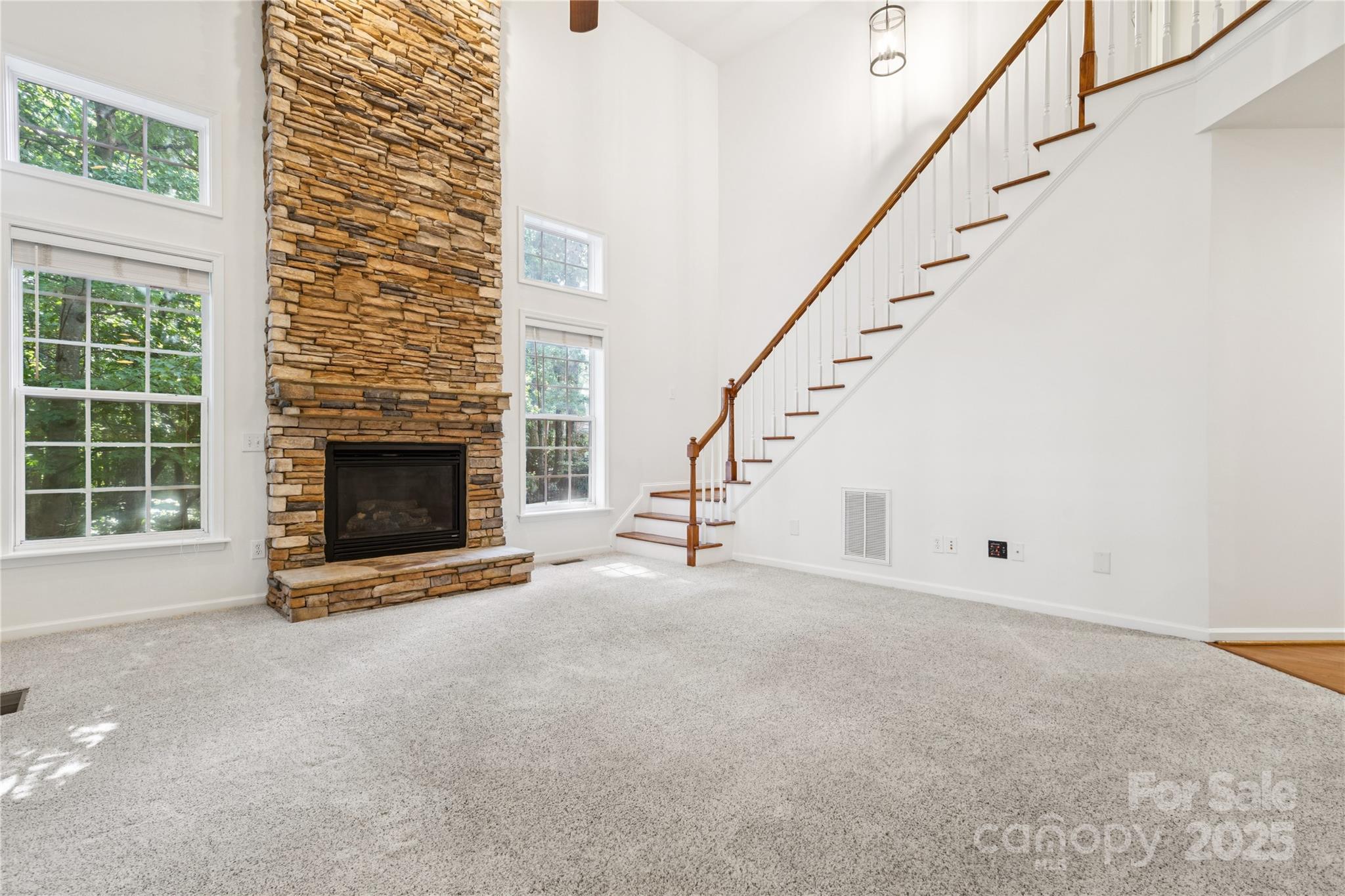 1627 Scotch Pine Lane Tega Cay, SC 29708 - Photo 15 of 48 a view of empty room with fireplace and stairs