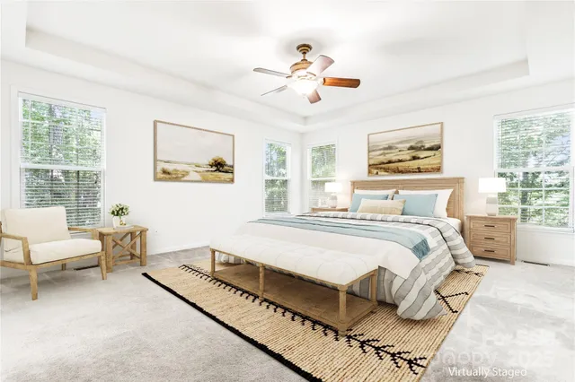 a spacious bedroom with a bed and a chandelier