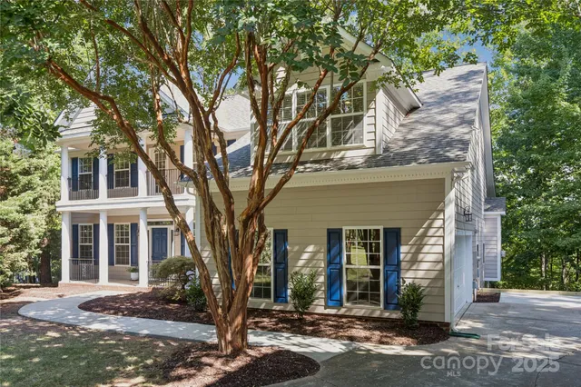 front view of a house with a tree