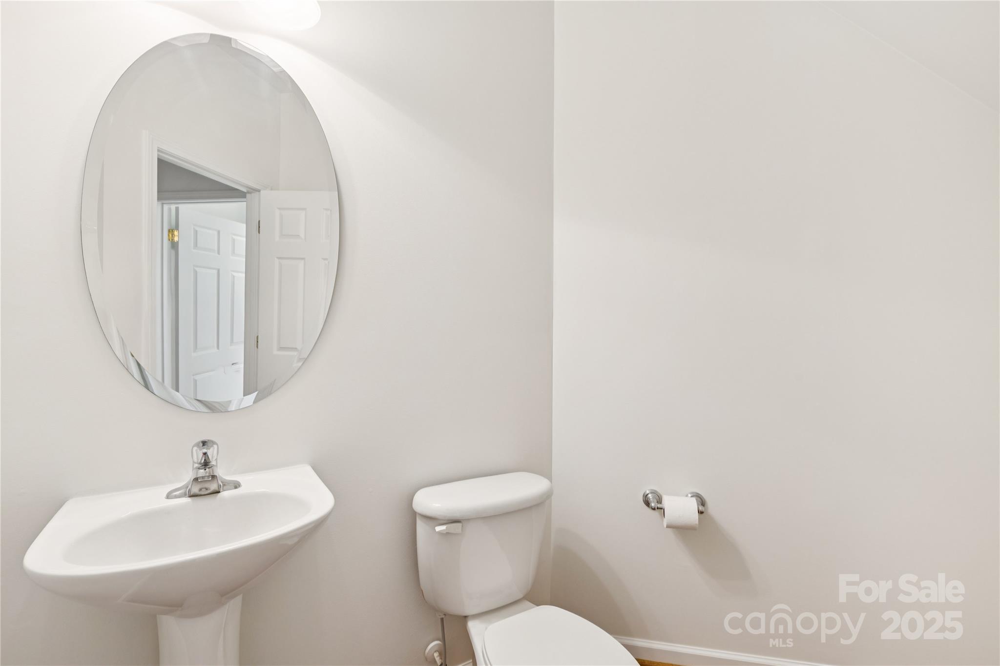 1627 Scotch Pine Lane Tega Cay, SC 29708 - Photo 22 of 48 a bathroom with a toilet a sink and a mirror