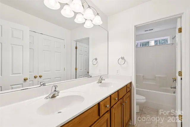 a bathroom with a sink a mirror and a shower