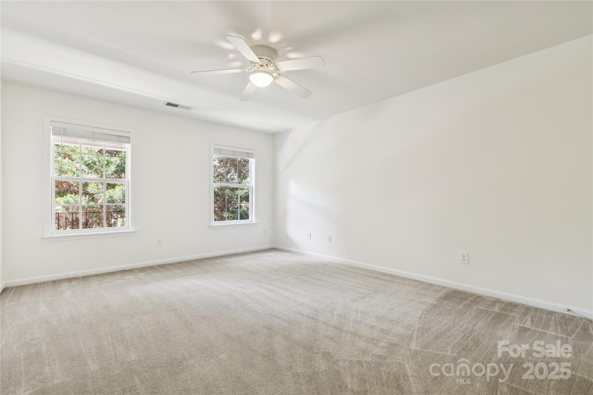 1627 Scotch Pine Lane Tega Cay, SC 29708 - Photo 28 of 48 an empty room with windows and fan
