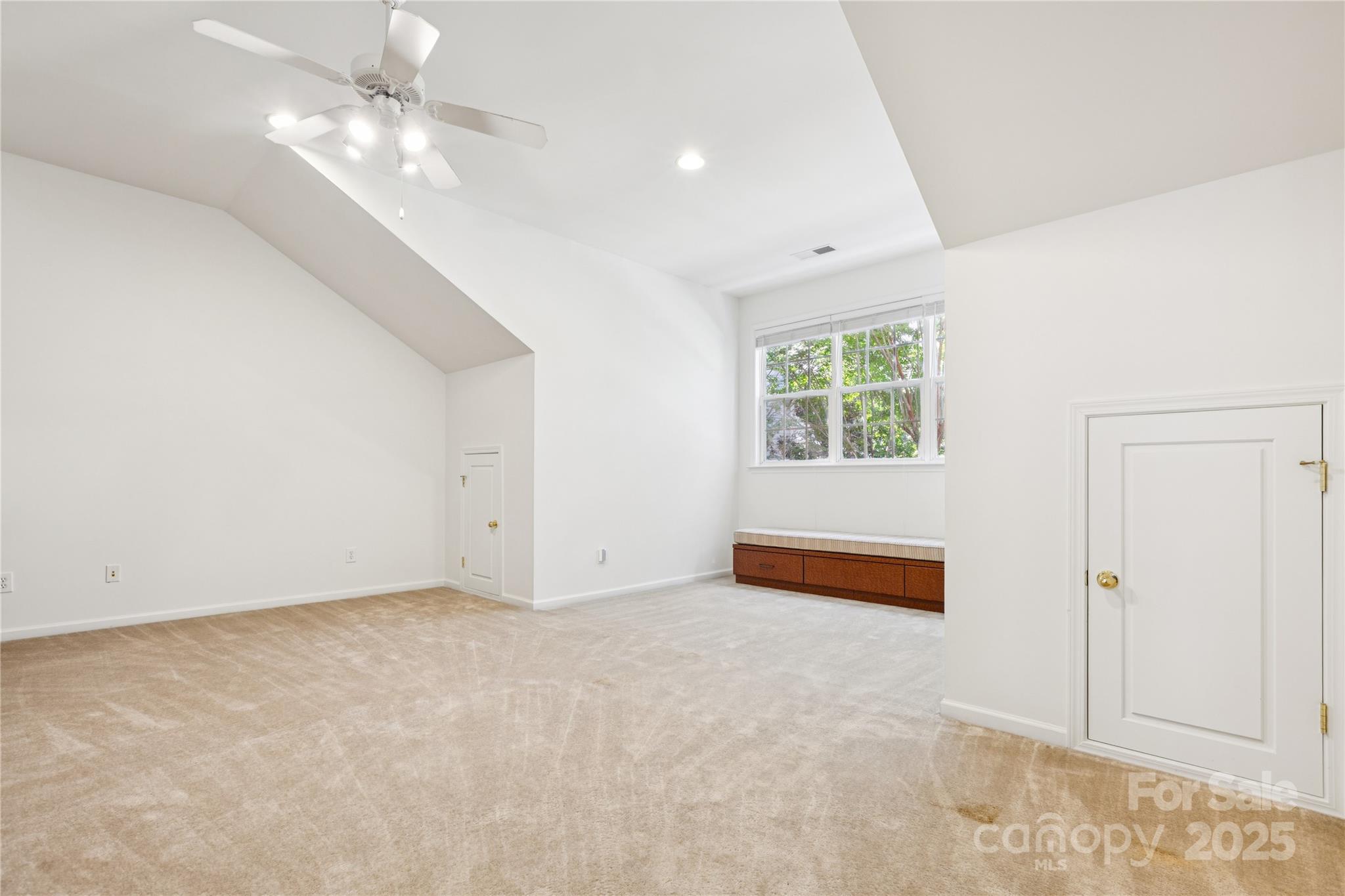1627 Scotch Pine Lane Tega Cay, SC 29708 - Photo 32 of 48 an empty room with windows and ceiling fan
