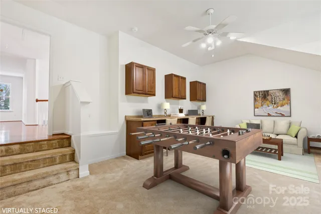 a view of kitchen with cabinets and window