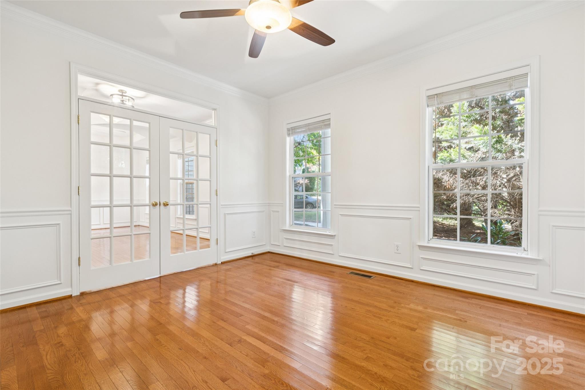 1627 Scotch Pine Lane Tega Cay, SC 29708 - Photo 6 of 48 a view of an empty room with a window and wooden floor
