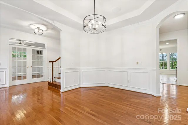 a view of a room with wooden floor and white walls