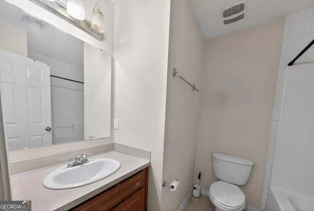 a bathroom with a sink toilet and a mirror