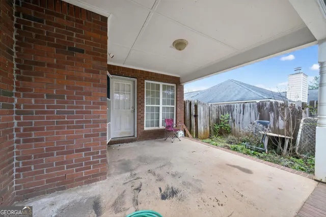 a view of a backyard with wooden fence