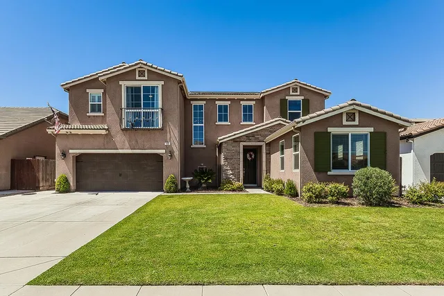 a front view of a house with a yard