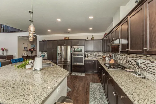 a utility room with stainless steel appliances and shelf