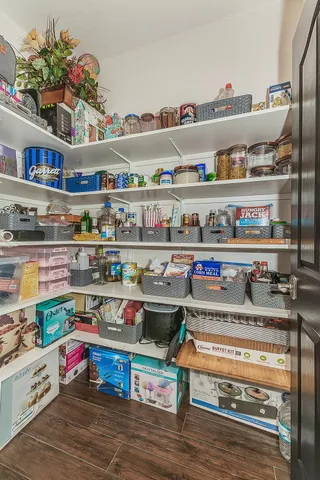 a utility room with stainless steel appliances and shelf