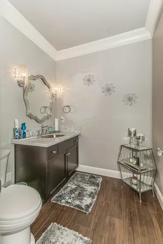 a bathroom with a toilet sink and mirror