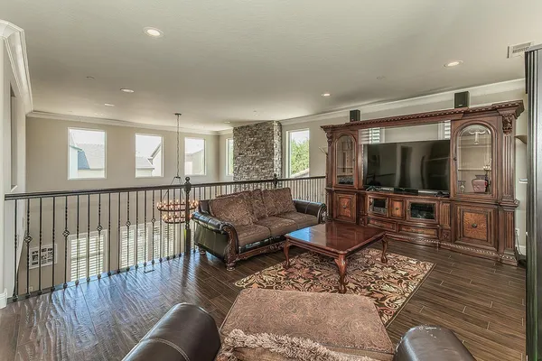 a livingroom with furniture a rug and a chandelier