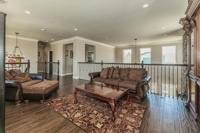 a living room with furniture and a wooden floor