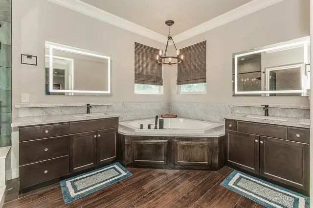 a spacious bathroom with a sink double vanity granite and a mirror