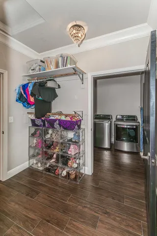 a kitchen with stainless steel appliances a stove a microwave and a hard wood floor