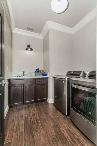 a livingroom with furniture a rug and a chandelier