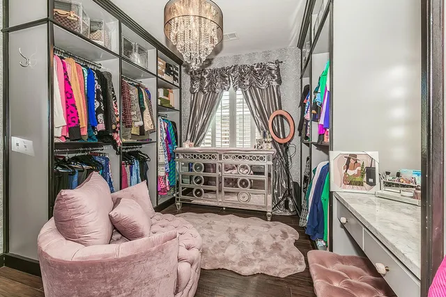 a view of walk in closet with clothes