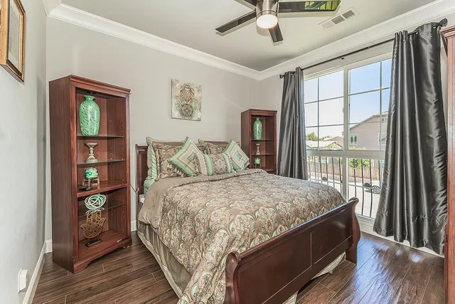 a bedroom with a bed closet and flat tv screen
