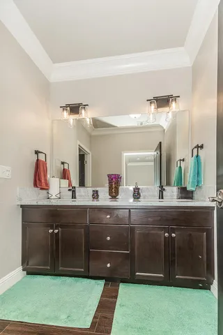 a spacious bathroom with a granite countertop sink mirror and toilet