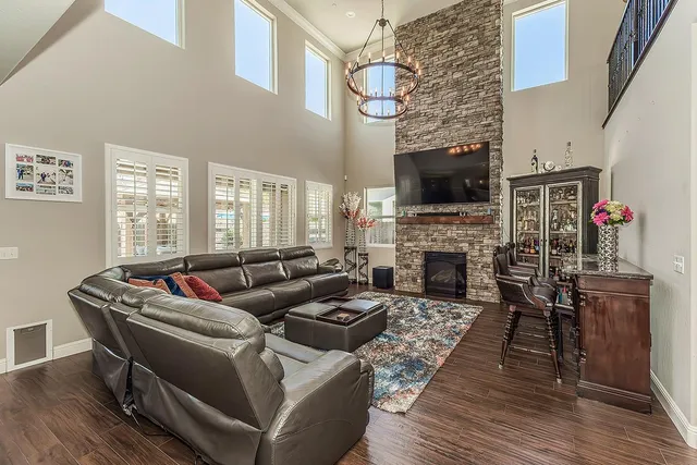 a living room with furniture a flat screen tv and a fireplace