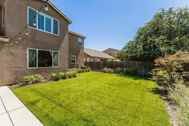a view of house with yard and entertaining space