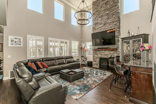 a living room with furniture a flat screen tv and a fireplace