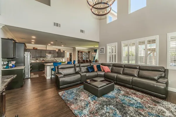 a kitchen with stainless steel appliances granite countertop a sink stove and wooden floor