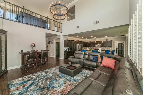 a kitchen with stainless steel appliances granite countertop a sink refrigerator and cabinets