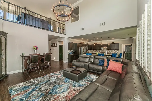 a living room with lots of furniture and kitchen view
