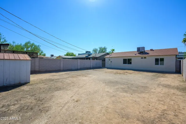 a view of a house with a yard and a large parking space