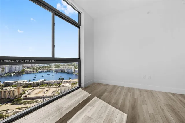 a living room with furniture and large windows