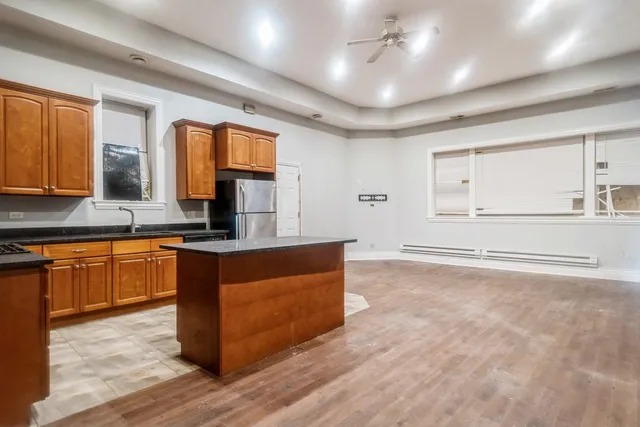 a kitchen with stainless steel appliances granite countertop a sink stove and cabinets