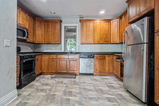 a kitchen with stainless steel appliances granite countertop a refrigerator stove top oven a sink and dishwasher