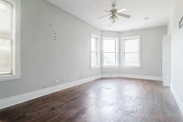 wooden floor in an empty room with a window