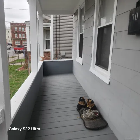 a hallway with a wooden floor and a potted plant