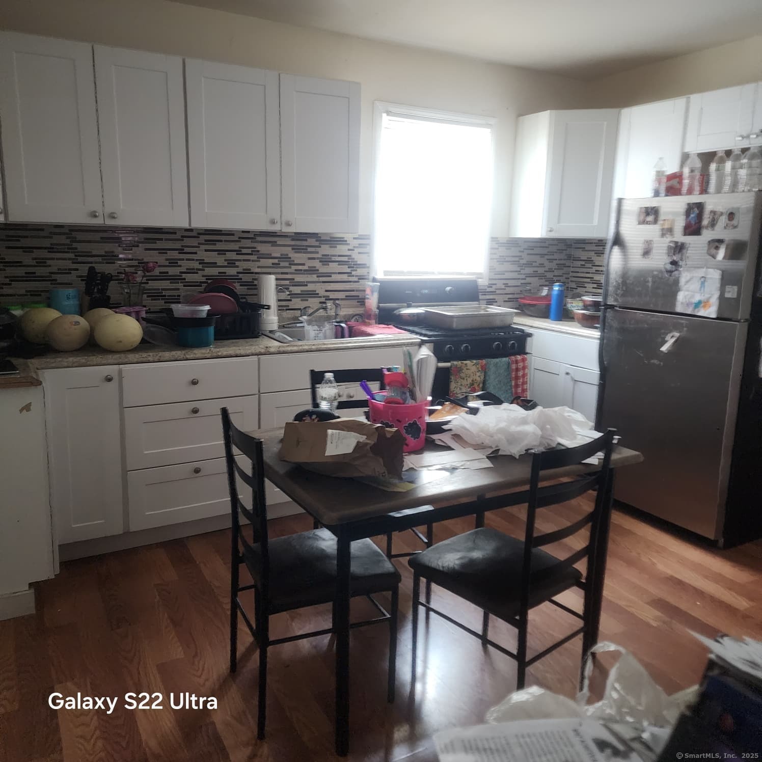 68 Edwin Street Bridgeport, CT 06607 - Photo 8 of 23 a kitchen with a dining table cabinets and a window