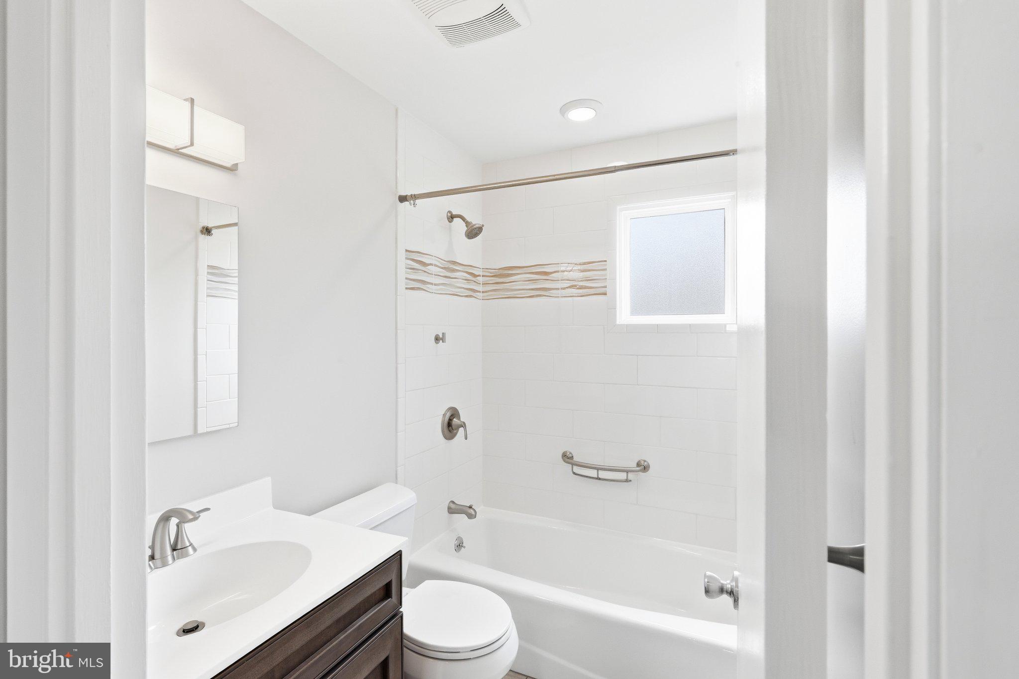9005 Perring Park Road Baltimore, MD 21234 - Photo 13 of 20 a bathroom with a granite countertop sink a toilet and shower
