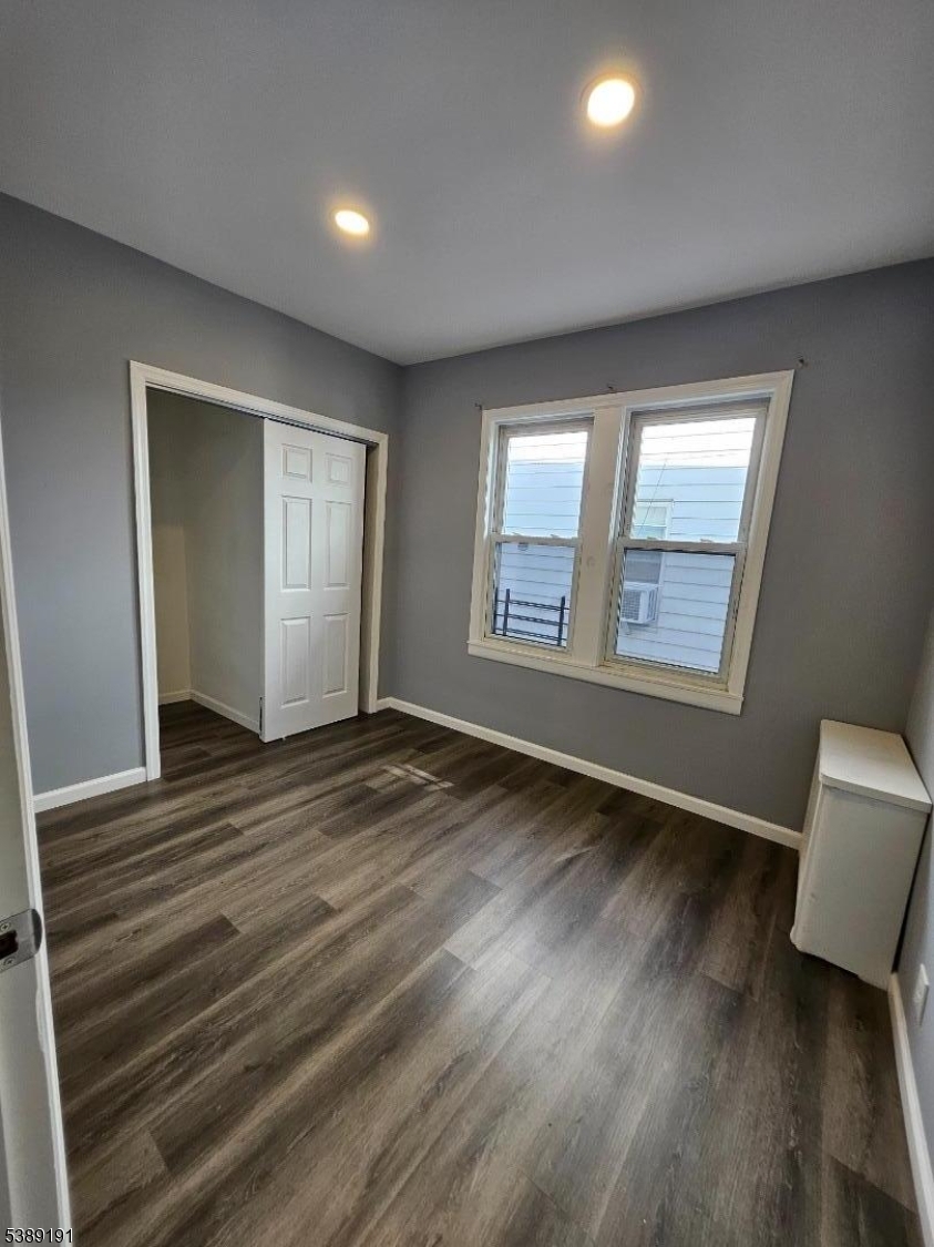 228 West End Avenue Newark, NJ 07106 - Photo 13 of 19 a view of an empty room with wooden floor and a window