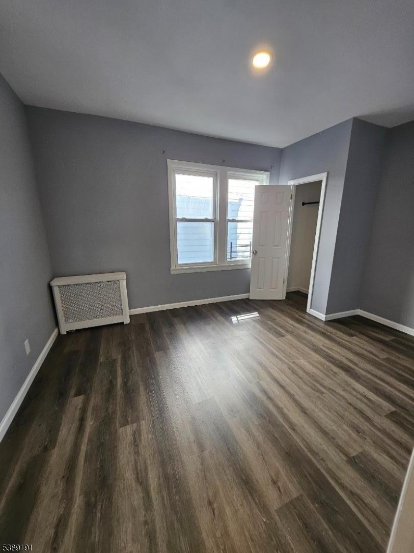 228 West End Avenue Newark, NJ 07106 - Photo 15 of 19 an empty room with wooden floor and windows