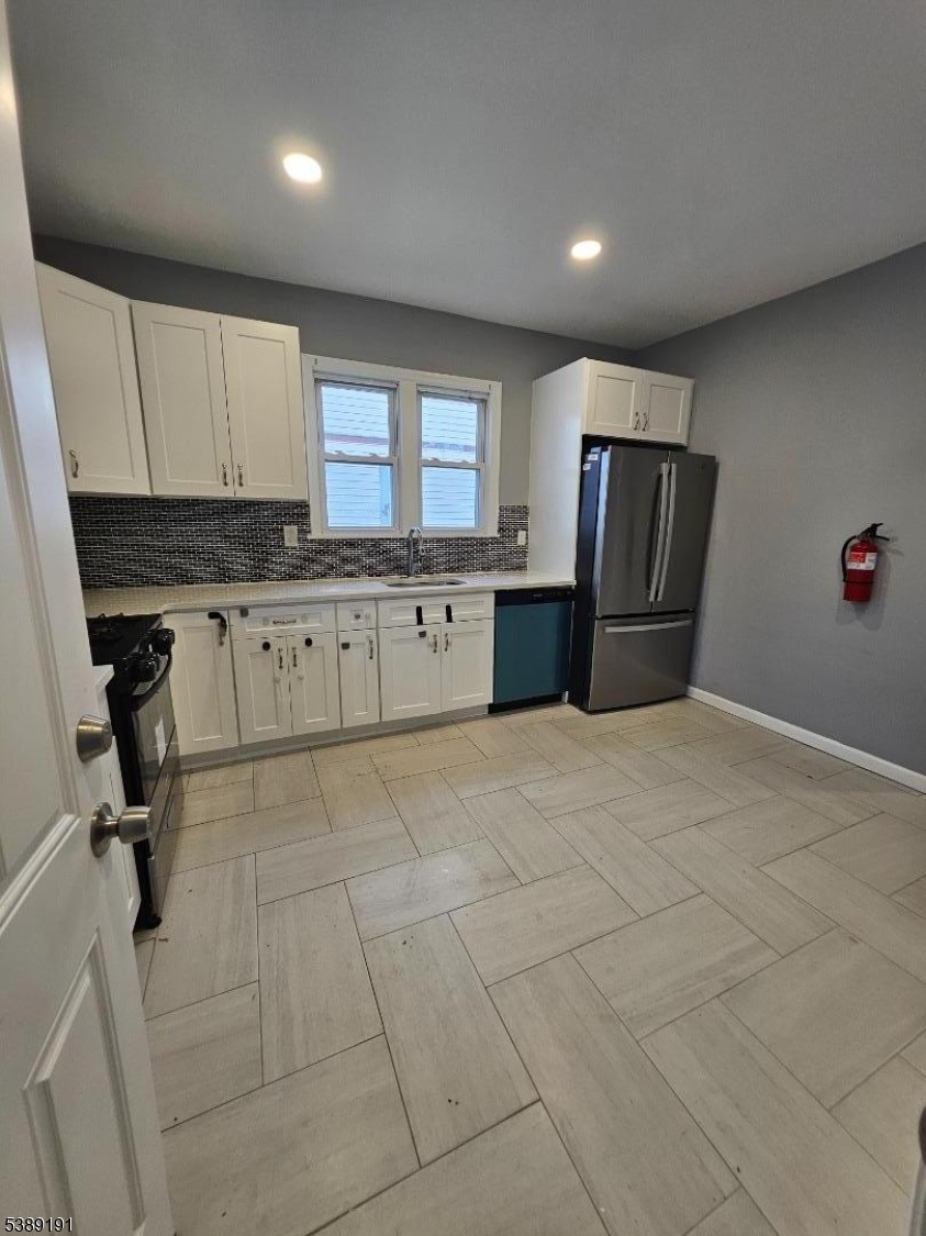 228 West End Avenue Newark, NJ 07106 - Photo 19 of 19 a kitchen with granite countertop a refrigerator and a sink