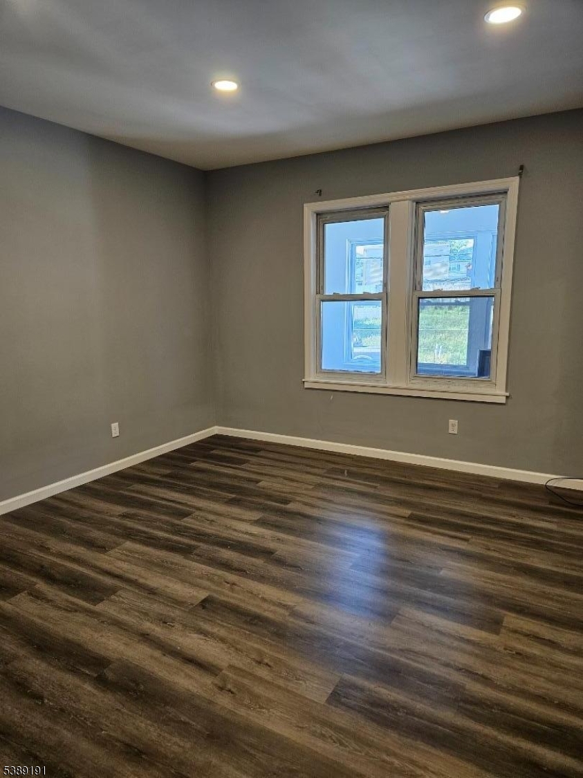 228 West End Avenue Newark, NJ 07106 - Photo 8 of 19 a view of an empty room with wooden floor and a window