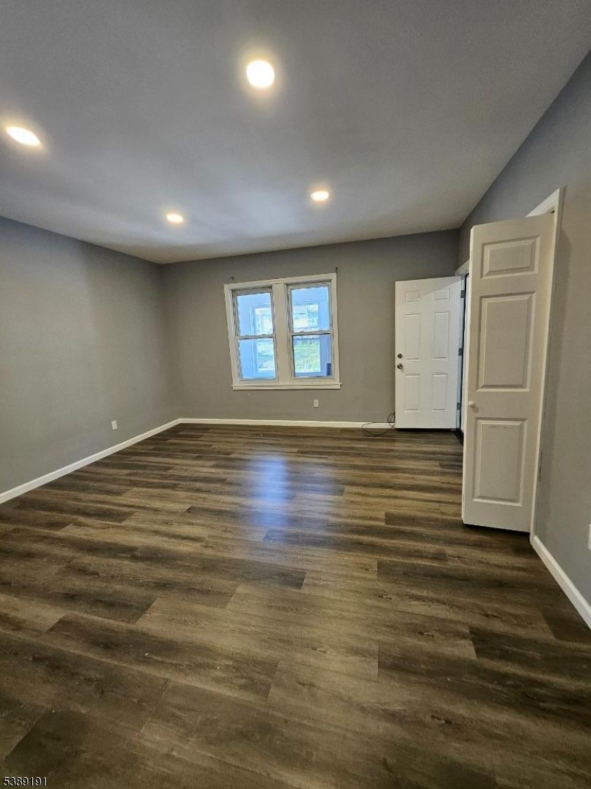 228 West End Avenue Newark, NJ 07106 - Photo 9 of 19 an empty room with wooden floor and windows