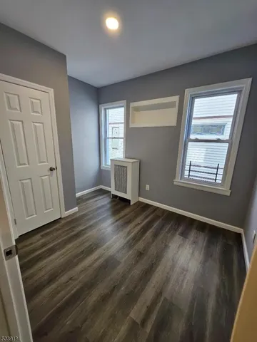 a view of a room with wooden floor and window