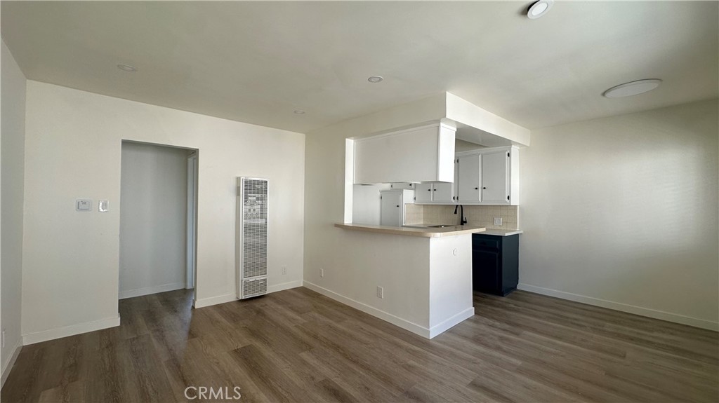 a kitchen with granite countertop a sink and a stove top oven