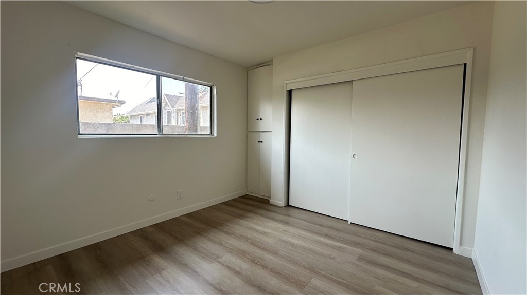 525 Howard Street, Unit E Alhambra, CA 91801 - Photo 5 of 5 a view of an empty room with wooden floor and a window