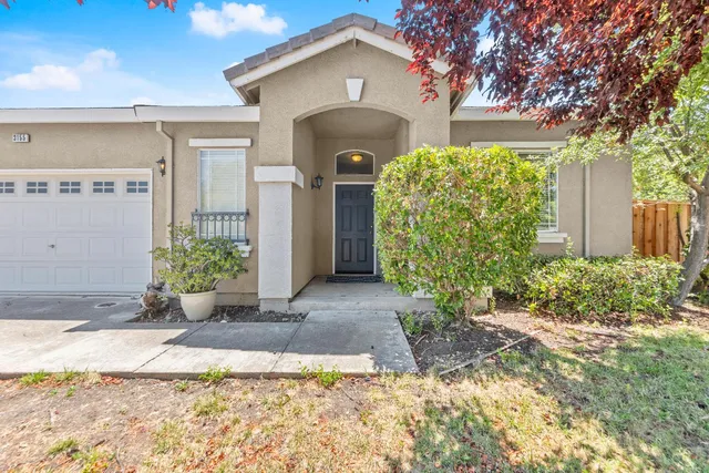 a front view of a house with garden