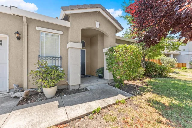 a front view of a house with a yard and seating space